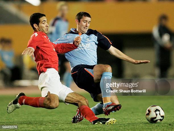 Terry McFlynn of Sydney FC is challenged by Mohamed Aboutrika of Al Ahly during the FIFA Club World Championship Toyota Cup 2005 match between Al...
