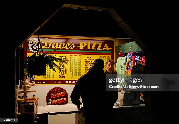 Pete Fenson talks with a customer at his restaurant, Dave's Pizza, September 27, 2005 in Bemidji, Minnesota. Fenson is a curler and will represent...