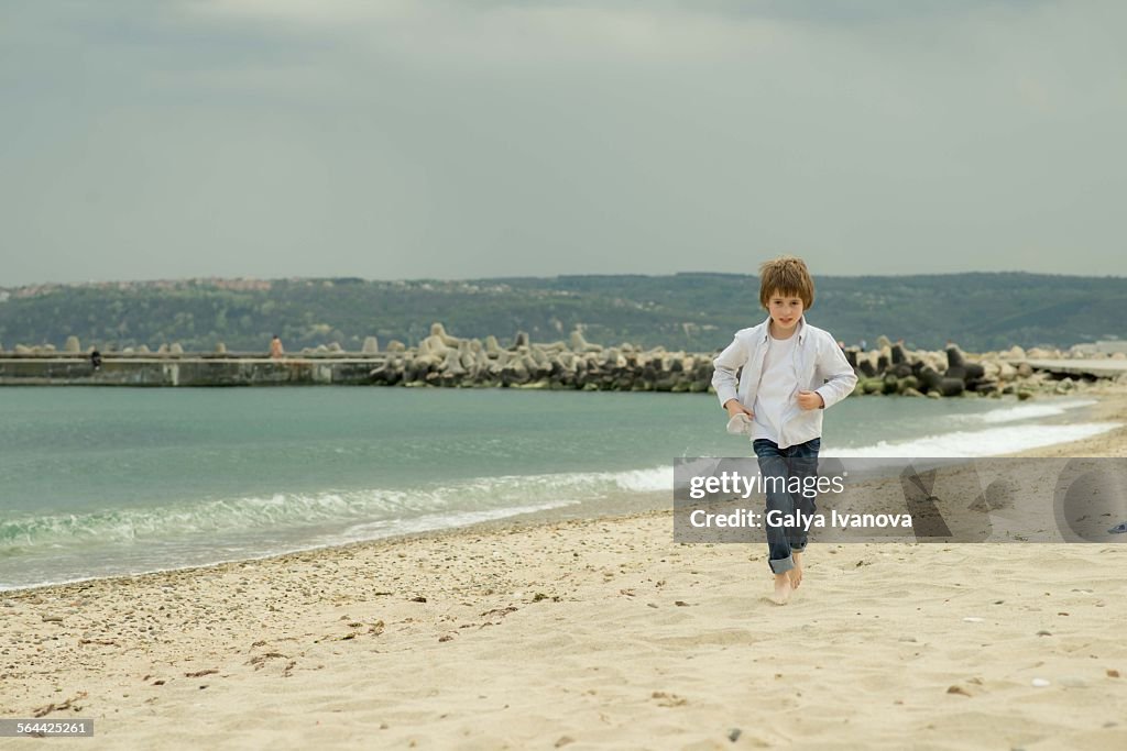 Boy running at the beach