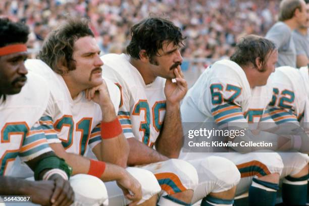 To R0 Runningbacks Mercury Morris, Jim Kiick, and Larry Csonka, of the Miami Dolphins, on the bench during a game against the New England Patriots on...