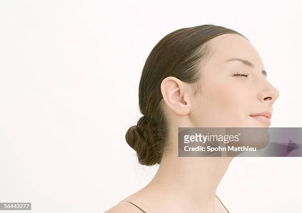 young woman closing eyes - three quarter length stock pictures, royalty-free photos & images