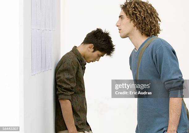 two students standing near results posted on wall - baccalaureat stock pictures, royalty-free photos & images