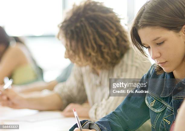 students writing in class - bac stock-fotos und bilder