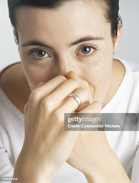 woman covering mouth and nose with hands, portrait - nose ring stock-fotos und bilder