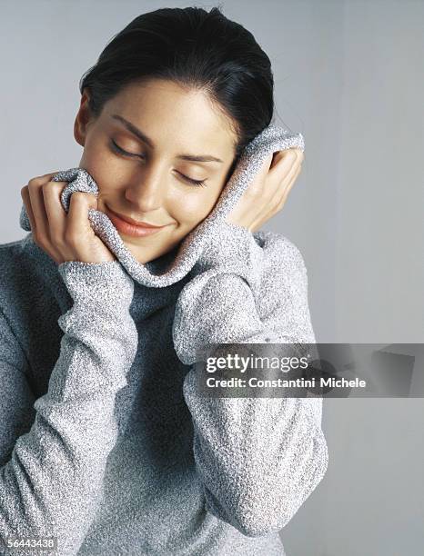 woman snuggling in sweater, portrait - polo neck stock pictures, royalty-free photos & images