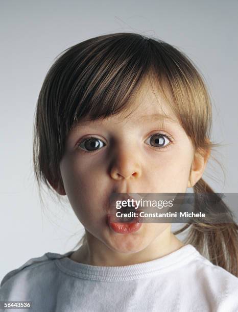 little girl making face, portrait - surprise face kid stock-fotos und bilder