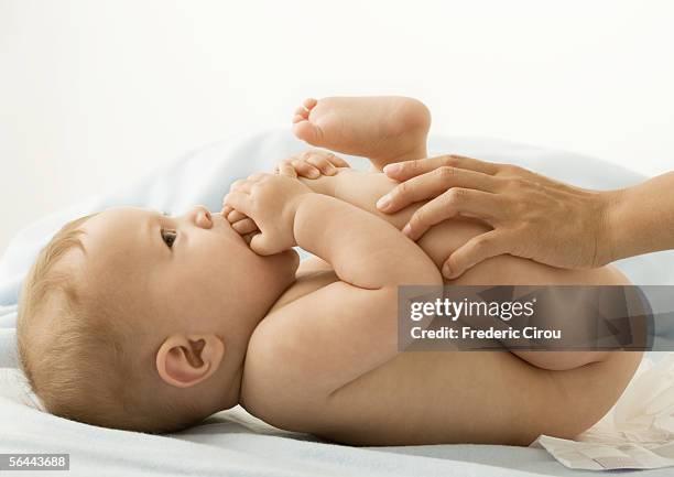 baby having diaper changed - adult baby boy diaper change foto e immagini stock