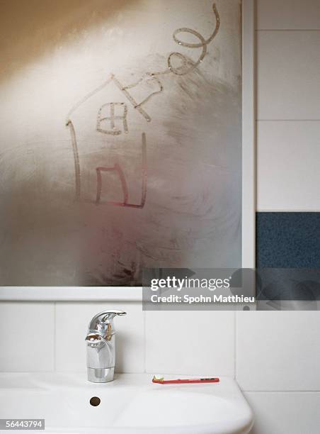 house drawn in condensation on bathroom mirror - mirror steam stock-fotos und bilder