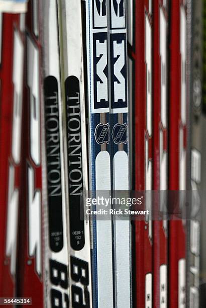 Detailed view of hockey sticks marked 'Thornton' lined up at the bench area during the NHL game between the San Jose Sharks and the Buffalo Sabres on...