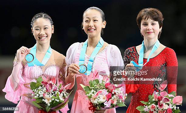 Yukari Nakano of Japan , Mao Asada of Japan and Irina Slutskaya of Russia pose with their medals after competing in the Ladies' Free Skating event of...