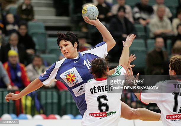 Romanian Steluta Luca jumps to score next to Hungary's Orsolya Verten and Timea Toth during their semi-finals handball match of XVIIth Women's World...