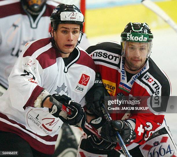 Latvian Aleksands Macjevskis vies with Sandy Jeanin of Switzerland's national hockey team during the International hockey tournament LOTO CUP 2005...