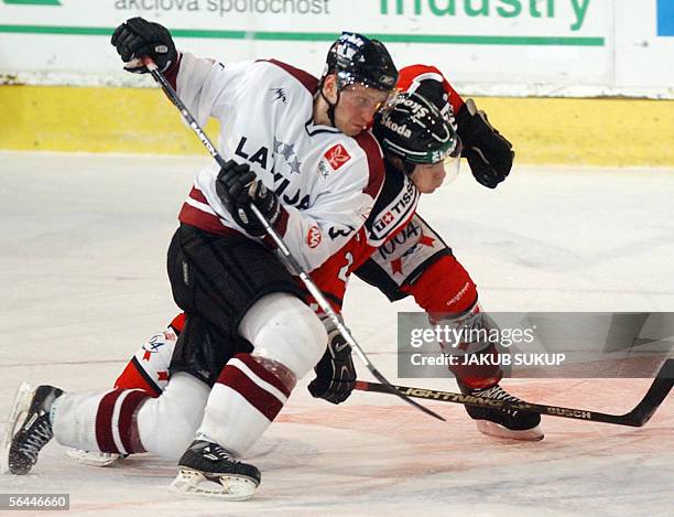 Latvian Arvids Rekis fights with Valentin Wirz of Switzerland's national hockey team during the International hockey tournament LOTO CUP 2005 between...