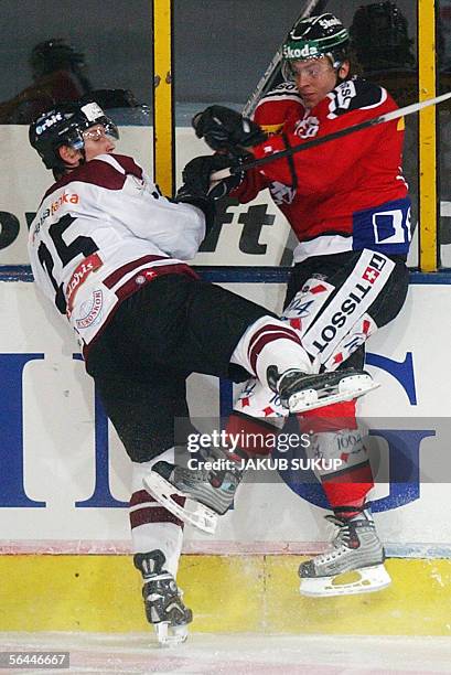 Latvian Georgis Pujacs crashes with Kevin Romy of Switzerland's national hockey team during the International hockey tournament LOTO CUP 2005 between...