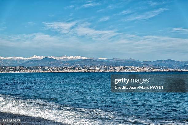 seascape, mountain with snow in french riviera - jean marc payet stock-fotos und bilder