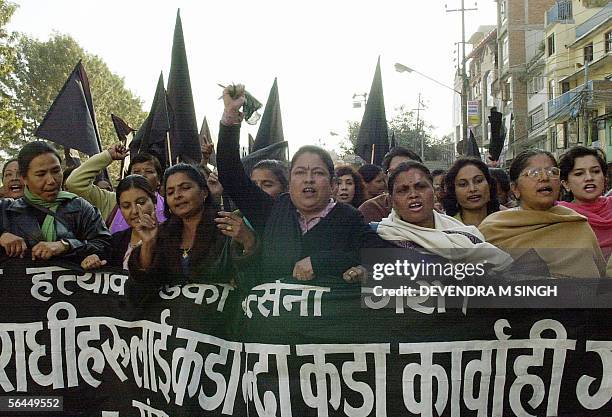 Nepalese women political activists shout slogans during a protest against the killings 14 December of 11 civilians by a soldier who then killed...
