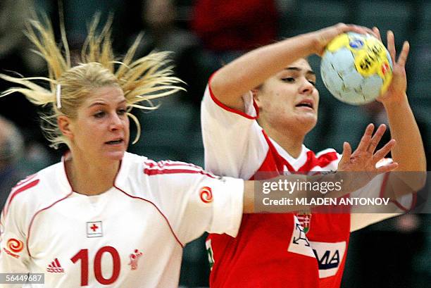 Rikke Horlykke Jorgensen of Denmark vies for the ball with Hungary's Orsolya Verten during their match for the third place of the XVII Handball...