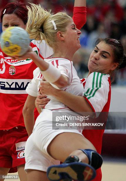 Denmark's Rikke Horlykke Jorgensen attacks as Hungary's Orsolya Verten tries to stop her during their handball match for the third place of the...