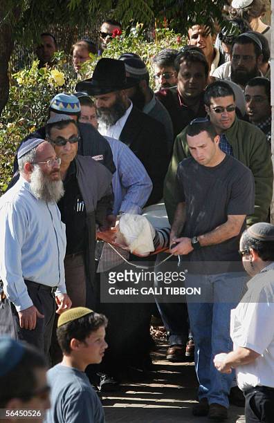 Friends and relatives of 35-year-old Israeli settler Yossi Shok carry his body during the funeral procession at the Beit Hagay settlement in the...