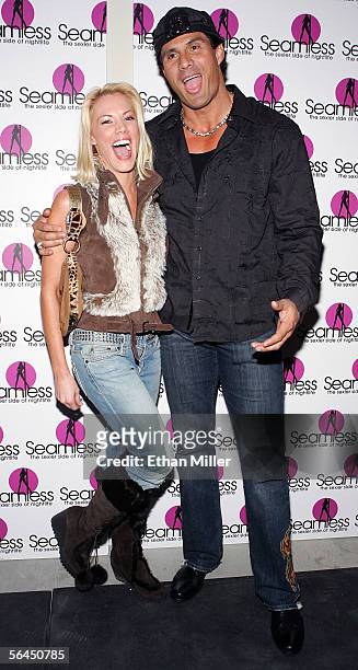Former Major League Baseball player Jose Canseco jokes around with his friend Denise Pernula as they arrive at the grand opening of the Seamless...