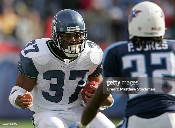 Shaun Alexander of the Seattle Seahawks attempts to elude Pacman Jones of the Tennessee Titans December 18, 2005 at The Coliseum in Nashville,...