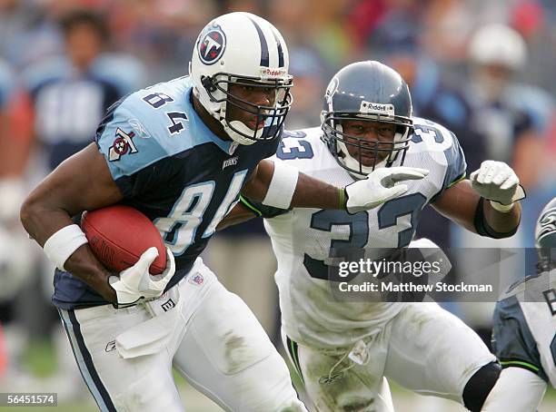 Ben Troupe of the Tennessee Titans attempts to elude Marquand Manuel of the Seattle Seahawks December 18, 2005 at The Coliseum in Nashville,...