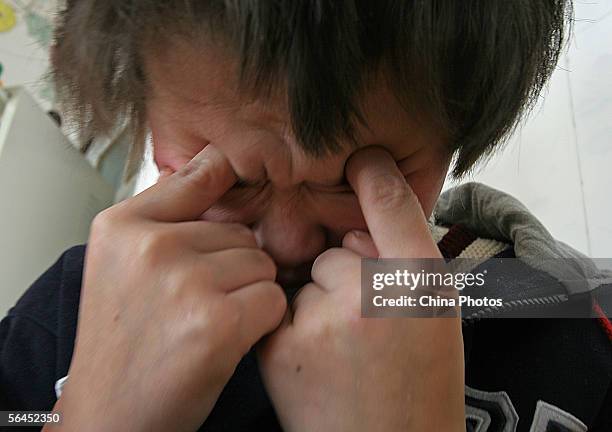 Child suffering from infantile autism reacts during rest at the Xining Orphan and Disabled Children Welfare Center on December 17, 2005 in Xining of...