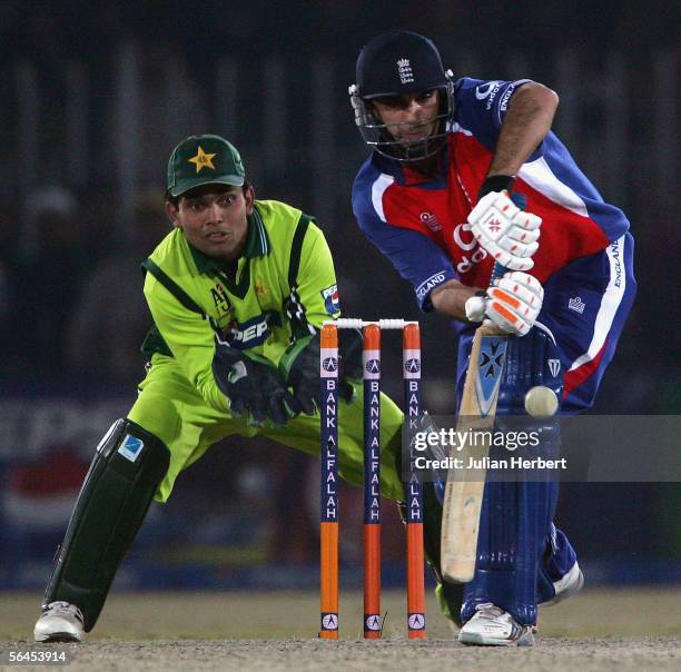 Kabir Ali of England is watched by Kamran Akmal of Pakistan as he bats during the fourth One Day International between Pakistan and England played at...