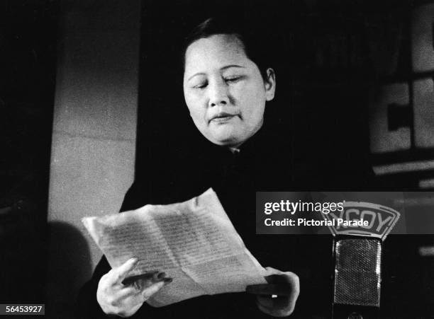 Chinese political figure Ching-ling Soong , better known as Madame Sun Yat-sen, reads a piece of paper she holds in her hands as she prepares to...