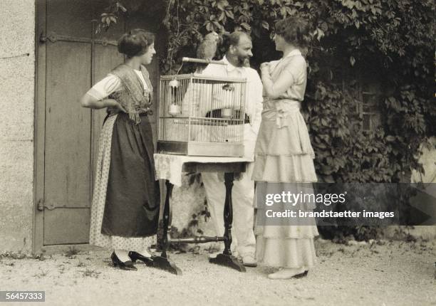 Gustav Klimt with Helene Klimt and Emilie Floege with a birdcage in Weissenbach at the Attersee lake. Photography. 1914. [Gustav Klimt mit Helene...