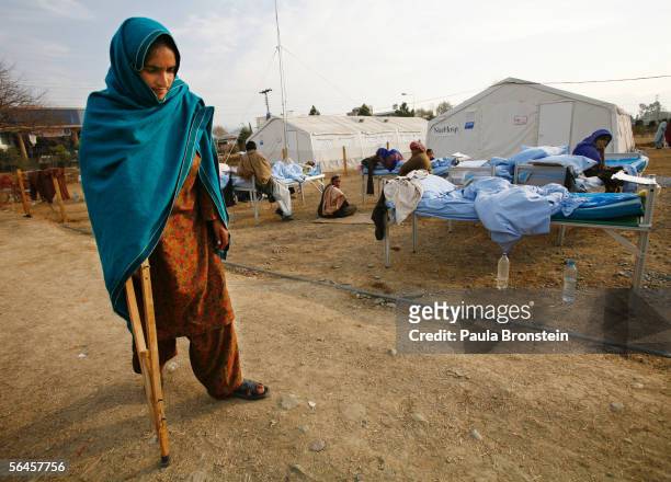 An earthquake survivor recovering from a fracture walks to her bed at the International Federation of Red Cross hospital December 19, 2005 in...