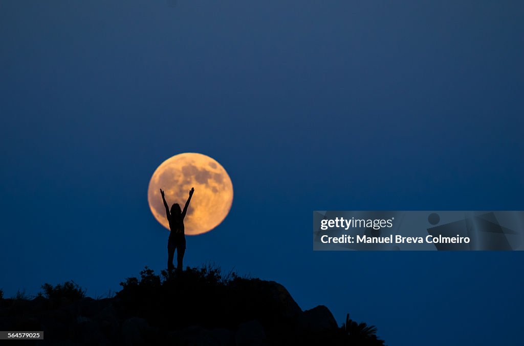 Woman silhouette on the full moon