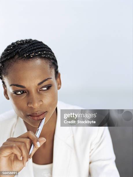 close-up of a businesswoman holding a pen - cornrows stock pictures, royalty-free photos & images