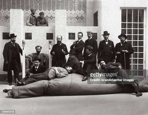 Group portrait of the artists of the Viennese Secession. Gustav Klimt in his pinafore and Kolo Moser sitting in front of Klimt. Photography by Moriz...