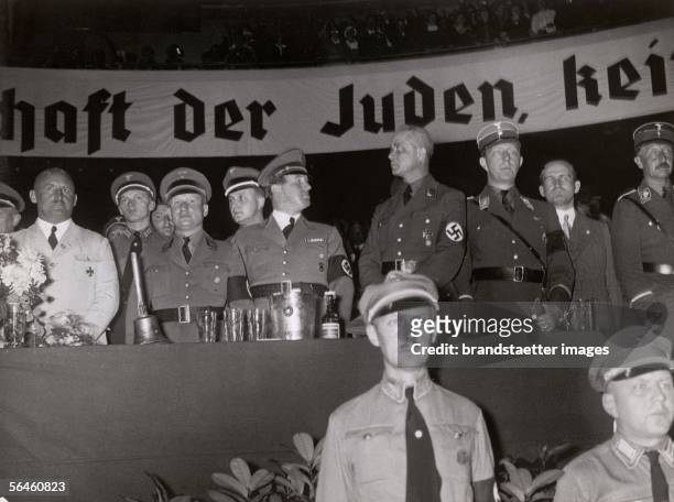 Holocaust: national socialist politicians on the honorary tribune. Anti-Semitic presentation, in the background anti-Semitic banner, on the left...