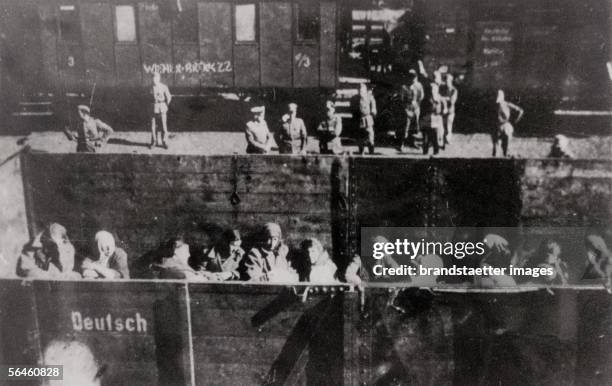 Holocaust: Deportation of Polish Jews in open cattle carriages at the "reloading point" in Warsaw, on the platform German soldiers. Poland....