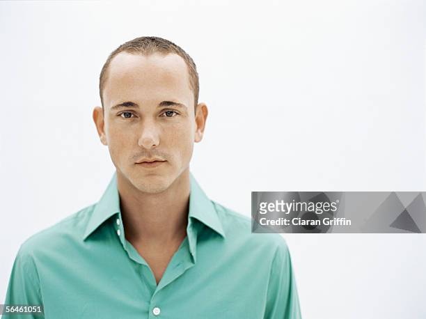 portrait of a young man standing - receding stock pictures, royalty-free photos & images