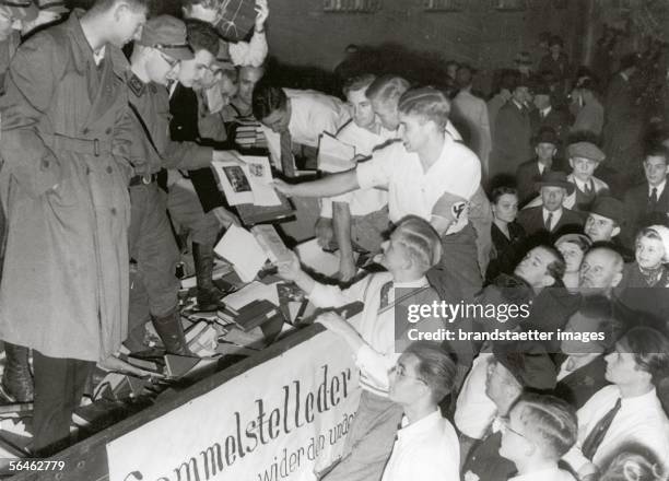 Students are collecting books for the book burning on Berlin's Opernplatz. The books are being uploaded and piled up to pyres. On May 10th 1933,...