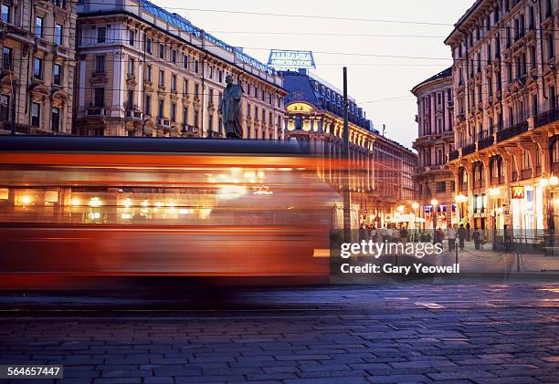 moving tram in milan at night - milan stock pictures, royalty-free photos & images