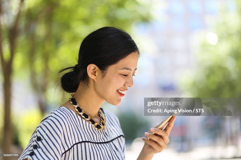 Businesswoman using mobile phone outdoor