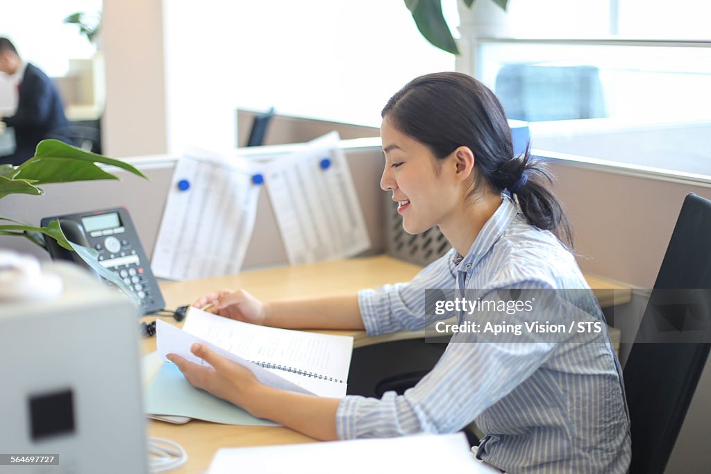 Businesswoman seated in office workstation