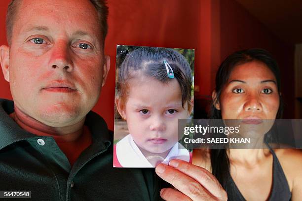 Sascha Meissmer from Frankfurt and Patchara Meissmer show a picture of their now five-year old daughter Solitair at their restaurant in Phuket, 20...