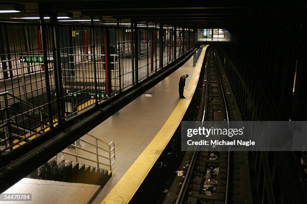 Ramon Donovan waits for a train to the Bronx in Union Square Station of the New York City subway system early Tuesday morning on December 20, 2005 in...