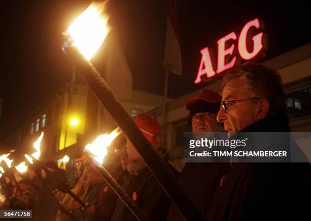 Employees of AEG, a brand of Swedish maker of electrical household appliances Electrolux, gather with torches to protest against the planned closure...