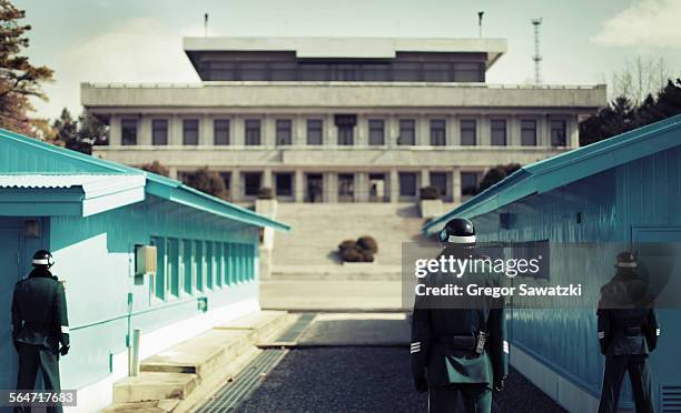 rear view of soldiers standing at korean demilitarized zone, south korea - demilitarized zone foto e immagini stock