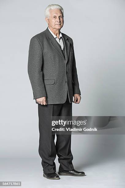 full length portrait of confident senior man standing over gray background - man full length isolated stock pictures, royalty-free photos & images