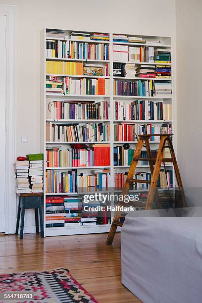 step ladder near bookshelves at home - bookcase stock pictures, royalty-free photos & images