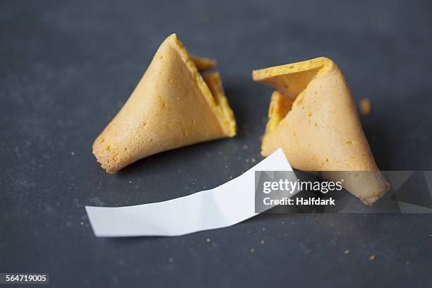 broken fortune cookie on table - fortune cookie stock pictures, royalty-free photos & images