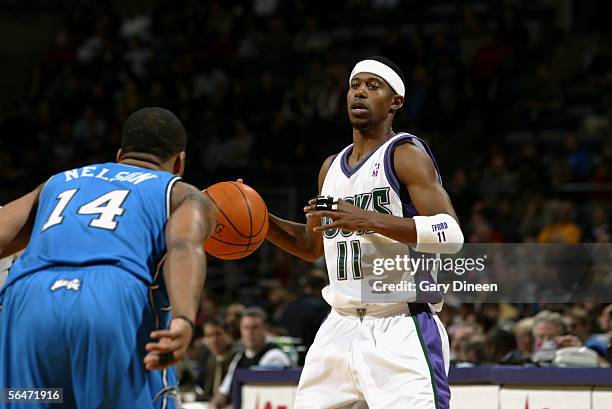 Ford of the Milwaukee Bucks is defended by Jameer Nelson of the Orlando Magic on December 3, 2005 at the Bradley Center in Milwaukee, Wisconsin. The...