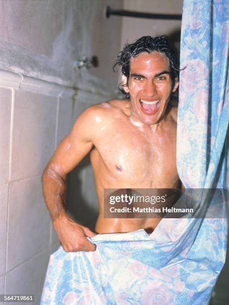 young sudsy man covering himself with shower curtain - shower curtain stock pictures, royalty-free photos & images